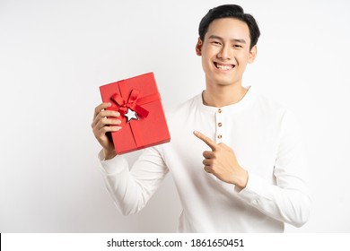 Asian businessman is holding red gift box on white background
 - Powered by Shutterstock