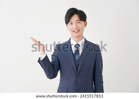 Asian businessman pointing side in white background