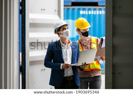 Asian businessman and Professional foreman woman work at Container cargo site check up premium goods in container, business Logistics oversea import export shipping industrial import-export transport.