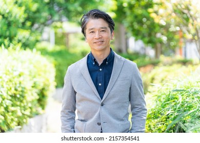 Asian Businessman Relaxing In The Park