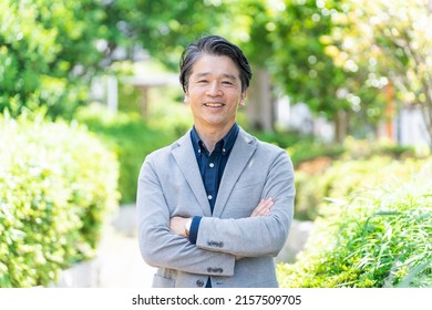 Asian Businessman Relaxing In The Park