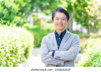 Asian Businessman Relaxing In The Park