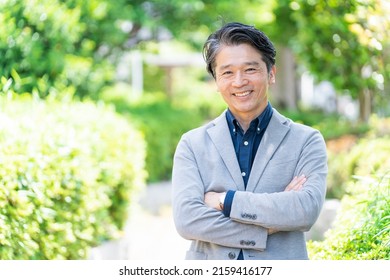 Asian Businessman Relaxing In The Park