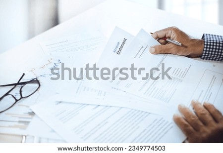 Asian businessman reviewing bank statement and bank account at office to apply for a business investment loan, check credit and plan borrowing to investment 