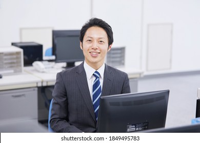 Asian Businessman Smiling At The Office