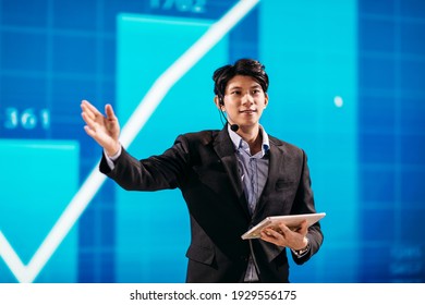 Asian Businessman Stands On Stage For Business Presentation 