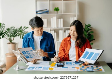 Asian businessman and woman people meeting in green office. Employee brainstorm and work as team, plan and discuss project by point on paper and tablet.  - Shutterstock ID 2273671237