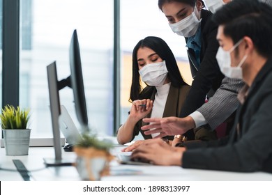 Asian Businessman And Woman In Suit Wear Protective Face Mask Work In Modern Office. Copy Space Concept Of New Normal Work To Prevent Spread Of Covid-19 Coronavirus After Business Reopening.