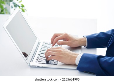 Asian Businessman Working With A Laptop At The Office, No Face