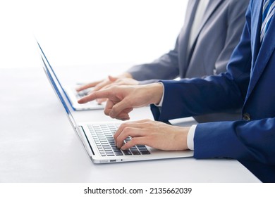 Asian Businessman Working With A Laptop At The Office, No Face