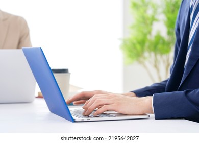 Asian Businessman Working With The Laptop At The Office, No Face