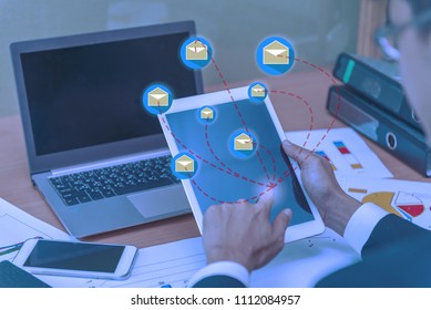 Asian businessman working on the desk with laptop,tablet,and smart phone from top view,Modern thai guy work in office,high angle of employee sitting for work in a company,Send email to customers - Shutterstock ID 1112084957