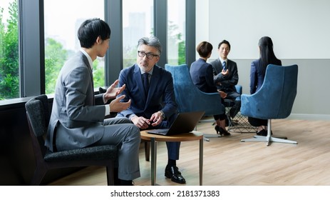 Asian Businessmen Meeting In The Office