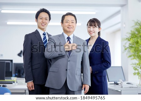 Asian businessmen smiling at the office