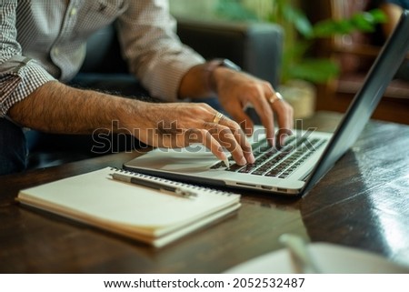Asian businessmen working and data analysis with computer labtop at coffee shop