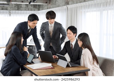 Asian businesspeople having a group meeting - Powered by Shutterstock