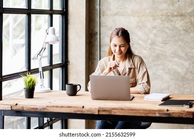 Asian businesswoman or accountant working on calculator to calculate business data, accounting document, and laptop computer at home office, business concept