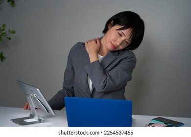 Asian businesswoman being tired after working overtime - Shutterstock ID 2254537465
