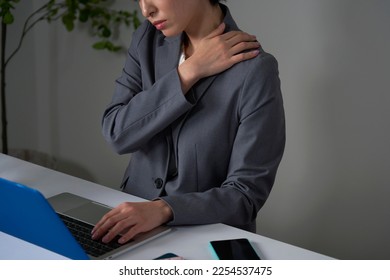 Asian businesswoman being tired after working overtime - Shutterstock ID 2254537475