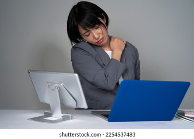 Asian businesswoman being tired after working overtime - Shutterstock ID 2254537483