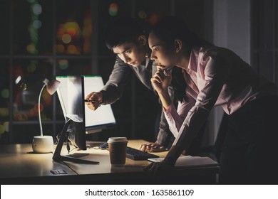 Asian Businesswoman And Businessman Working Hard Late Together With Technology Computer In Office, Customer Service And Call Center, Team Work With Colleagues For Success Achievement Project Concept