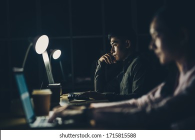 Asian Businesswoman And Businessman Working Hard Late Together With Technology Computer In Office, Customer Service And Call Center, Team Work With Colleagues For Success Achievement Project Concept