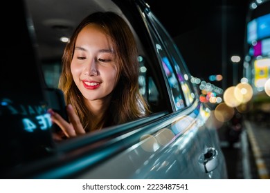 Asian businesswoman commuting from office in Taxi backseat with mobile phone on road in city at night after late work, Beautiful woman using smartphone sitting back seat her car in urban - Powered by Shutterstock