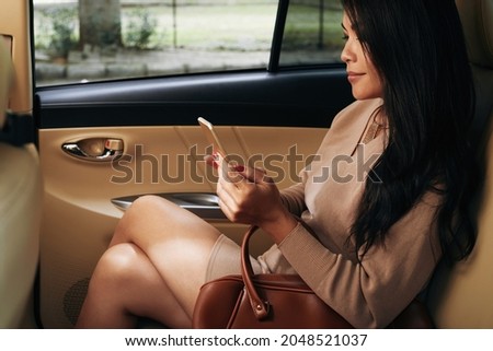 Asian Businesswoman Commuting In Taxi