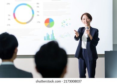 asian businesswoman giving a presentation at a seminar - Shutterstock ID 2173008037