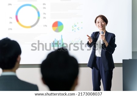 asian businesswoman giving a presentation at a seminar