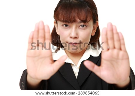 asian businesswoman making stop gesture