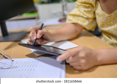 Asian businesswoman online working at home. Thai woman lifestyle in living room. Social distancing and new normal. - Shutterstock ID 1811658466