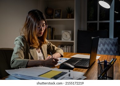 Asian businesswoman online working at the night. Busy and exhausted of work overtime at home - Shutterstock ID 2155172219