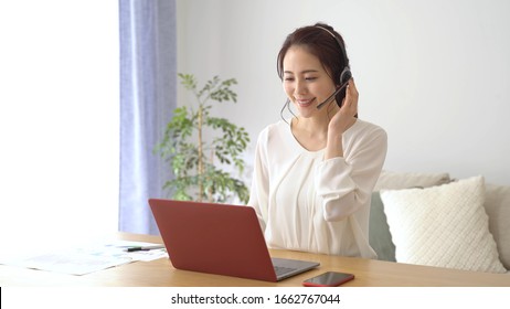  asian businesswoman remote working in home - Powered by Shutterstock