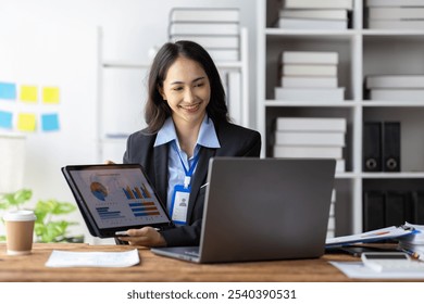 Asian businesswoman showing financial charts during video call. - Powered by Shutterstock