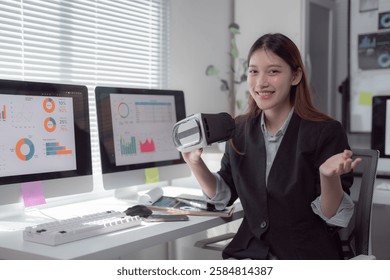 Asian businesswoman showing virtual reality headset presenting financial charts graphs and data analysis on computer screen in modern office, business and technology concept