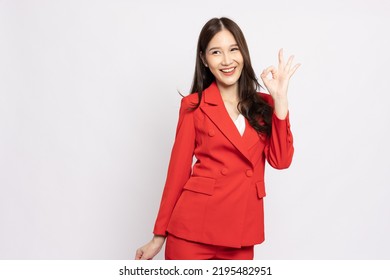 Asian businesswoman smiling and showing OK sign isolated on white background - Shutterstock ID 2195482951
