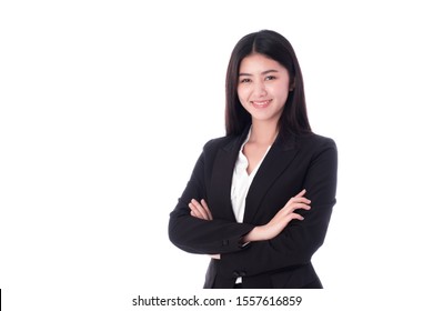 Asian businesswoman standing her arms folded over a white background She wears a black suit and stands smiling in a good mood. There is a copy space and isolating.