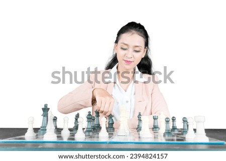 Asian businesswoman thinking playing chess while sitting in the studio, isolated on white background
