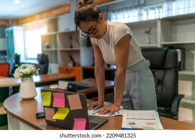 Asian businesswoman tired on business work. young adult exhausted office woman work late  at workplace feel alone and sad. quite serious sad female worker think about life after over work at office. - Shutterstock ID 2209481325