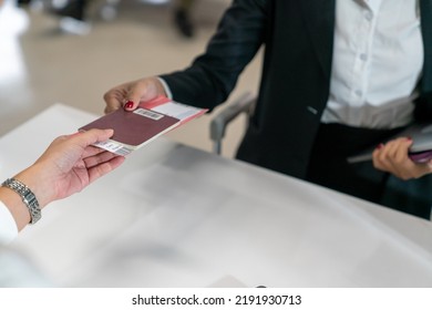 Asian Businesswoman Walking To Airline Ground Staff At Check In Counter And Get Boarding Pass Ticket At Airport Terminal. Commercial Airline Service Business And Global Airplane Transportation Concept