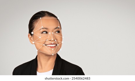 Asian businesswoman wearing a black jacket smiles confidently while facial recognition technology overlays geometric markings on her face. This showcases advancements in artificial intelligence. - Powered by Shutterstock