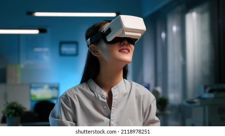 Asian Businesswoman Wearing Virtual Reality Headset In Modern Office. Portrait Of Young Female Entrepreneur Working In Vr Goggles. 