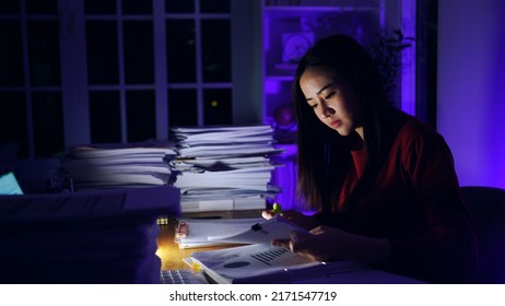 Asian businesswoman working hard late hours with a lot of document at home. Busy and exhausted of work overtime at night. - Shutterstock ID 2171547719