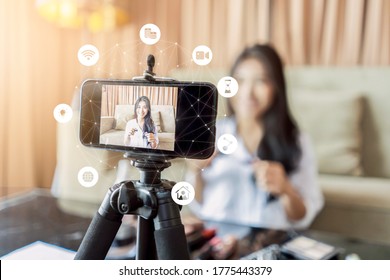 Asian Businesswoman Working From Home Live Video Interaction With Customers Using Camera Device Vlogging Selling Make Up Products, Viral Internet Social Media Influencer Interacting To Live Audience