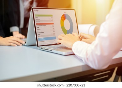 Asian businesswomen smiling and using notebook for analysis documents and graph financial diagram and self responsibility concept at office - Powered by Shutterstock