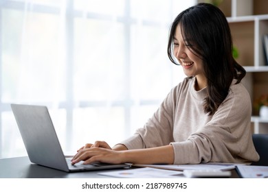 Asian Businesswomen Use Laptops And Smartphones In An Open Space Office. Business Concept. Data Analysis, Roadmap, Marketing, Accounting, Auditing. 