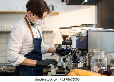 Asian Cafe Business Owner Wear Protective Mask Due To Covid19 Pandemic, Check Or Make Coffee From Machine On Counter Bar In Restaurant. Barista Man Prepare Order For Customer And Fix Work Equipment.