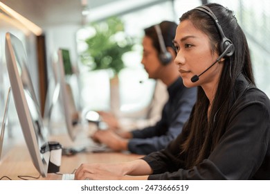 Asian call center team, customer service, telesales wearing headset or headphone talking with customer in the office - Powered by Shutterstock