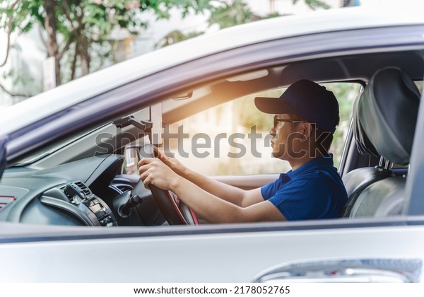 Asian car\
mechanic man test for driving a\
car.